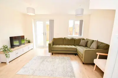 a living room with a couch and a tv at Modern 3 Bedroom House in Kirkdale Liverpool in Liverpool