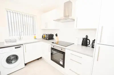 a white kitchen with a washer and dryer at Modern 3 Bedroom House in Kirkdale Liverpool in Liverpool
