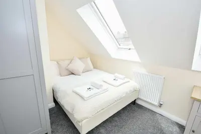 a small bedroom with a bed with two towels on it at Modern 3 Bedroom House in Kirkdale Liverpool in Liverpool