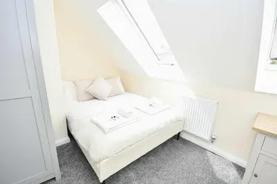 a small bedroom with a bed in a attic at Modern 3 Bedroom House in Kirkdale Liverpool in Liverpool