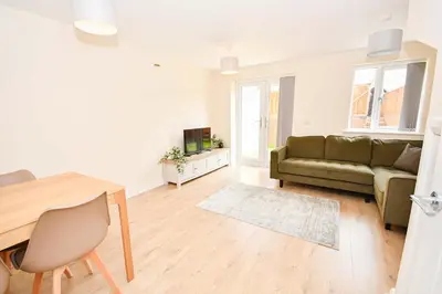 a living room with a couch and a table at Modern 3 Bedroom House in Kirkdale Liverpool in Liverpool