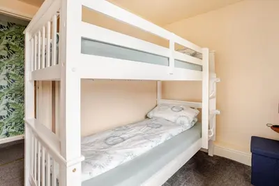 a white bunk bed in a small room at Cosy, coastal cottage- Beach, Pub and shop nearby in Haverigg
