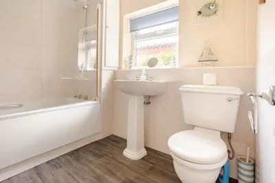 a bathroom with a toilet and a sink and a bath tub at Cosy, coastal cottage- Beach, Pub and shop nearby in Haverigg
