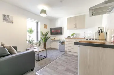 a kitchen and living room with a couch and a table at 1 Double Bedroom Apartment Central Blackpool 4 in Blackpool