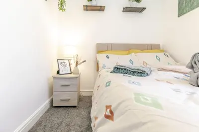 a bedroom with a bed and a night stand at 1 Double Bedroom Apartment Central Blackpool 4 in Blackpool