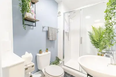 a white bathroom with a toilet and a shower at 1 Double Bedroom Apartment Central Blackpool 4 in Blackpool