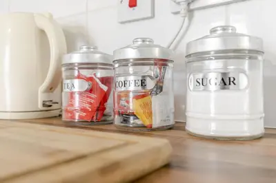 three jars sitting on top of a kitchen counter at 1 Double Bedroom Apartment Central Blackpool 4 in Blackpool