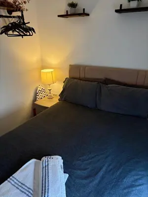 a bedroom with a bed and a table with a lamp at 1 Double Bedroom Apartment Central Blackpool 4 in Blackpool