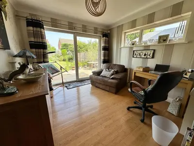 a living room with a desk and a chair at Birkdale Open - Four Bed Home in Southport