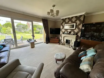 a living room with a couch and a fireplace at Birkdale Open - Four Bed Home in Southport