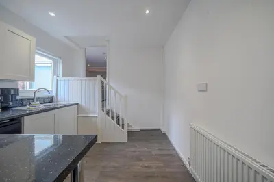 a kitchen with white walls and a counter top at Stunning 2 Bedroom 6 Guest Flat by Anfield Stadium in Liverpool