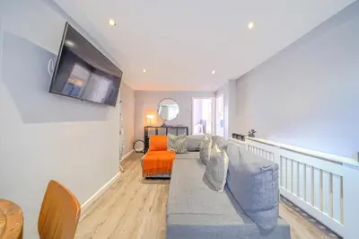 a living room with a couch and a tv at Stunning 2 Bedroom 6 Guest Flat by Anfield Stadium in Liverpool