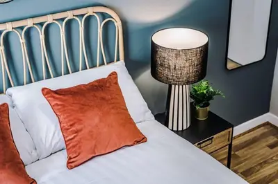 a bedroom with a bed with a lamp on a table at Central 2 Beds with Free Parking in Liverpool