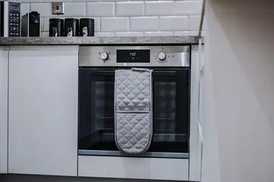 a tie hanging on an oven door in a kitchen at Central 2 Beds with Free Parking in Liverpool