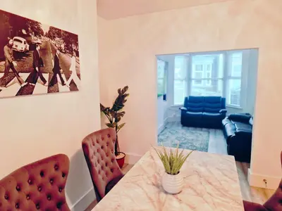a dining room with a table and chairs at 5 star Luxury Home by Liverpool Football Stadium in Liverpool