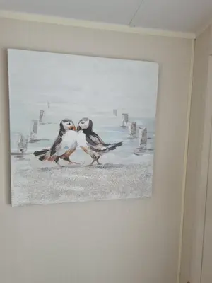 a painting of two birds on a wall at The Seaflower - With Lake Views in Millom