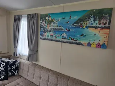 a painting on a wall above a couch at The Seaflower - With Lake Views in Millom