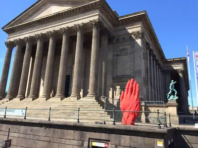 a red sculpture in front of a building at Elegant Apartment in Hamilton Square Free Parking in Birkenhead