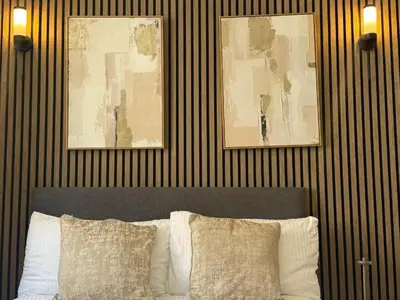a bedroom with a bed with two pictures on the wall at Luxury Double Liverpool City Centre Penthouses 8 Guests in Liverpool