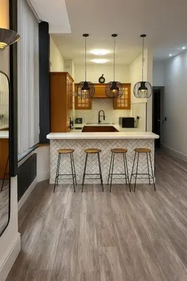 a kitchen with three bar stools and a counter at Luxury Double Liverpool City Centre Penthouses 8 Guests in Liverpool