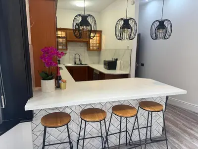 a kitchen with a counter with four stools at Luxury Double Liverpool City Centre Penthouses 8 Guests in Liverpool
