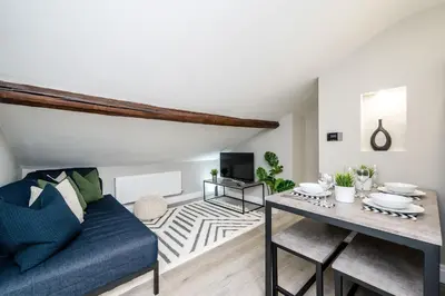 a living room with a blue couch and a table at Two Apartments in One , City Centre, Sleeps 11! in Liverpool