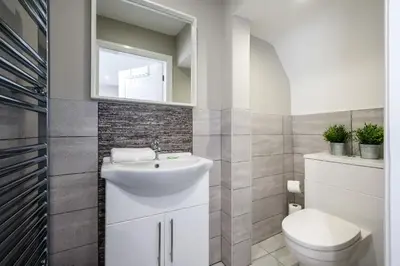 a bathroom with a white sink and a toilet at Two Apartments in One , City Centre, Sleeps 11! in Liverpool