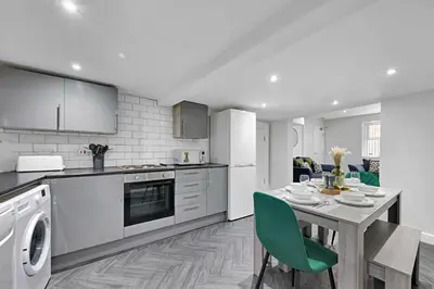 a kitchen with a table and a dining room at Kemble House - Air Host & Stay - 5 Bedroom, 5 Bathroom - Sleeping 10 in Prescot