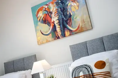 a painting of an elephant hanging above a bed at Kemble House - Air Host & Stay - 5 Bedroom, 5 Bathroom - Sleeping 10 in Prescot