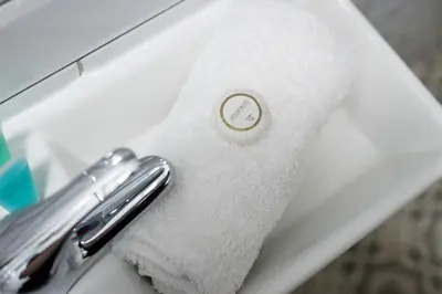 a towel on a sink with a white towel at Kemble House - Air Host & Stay - 5 Bedroom, 5 Bathroom - Sleeping 10 in Prescot