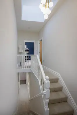 a white staircase in a home with a chandelier at Blackpool Beauty! - Full House - Sleeps 9 in Blackpool