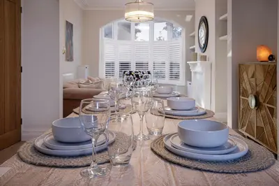 a dining table with wine glasses and plates on it at Blackpool Beauty! - Full House - Sleeps 9 in Blackpool