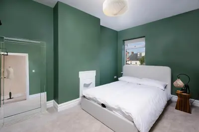 a bedroom with green walls and a white bed at Blackpool Beauty! - Full House - Sleeps 9 in Blackpool