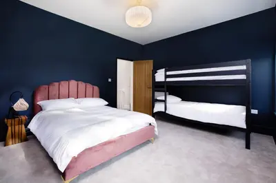 a bedroom with two bunk beds and blue walls at Blackpool Beauty! - Full House - Sleeps 9 in Blackpool