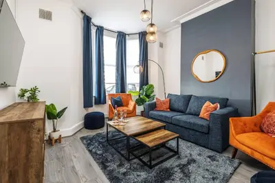 a living room with a couch and a table at Anfield Abode in Liverpool