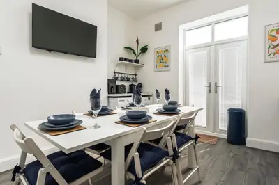 a dining room with a white table and chairs at Anfield Abode in Liverpool