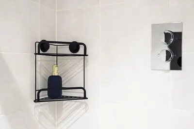 a black soap bottle on a shelf in a bathroom at Anfield Abode in Liverpool
