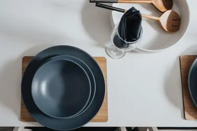 a black plate on a white table with a spoon at Anfield Abode in Liverpool