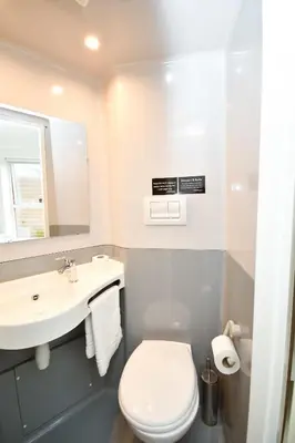 a bathroom with a white toilet and a sink at Spacious 6 Bedroom Apartment in Liverpool in Liverpool