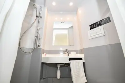 a bathroom with a sink and a shower at Spacious 13 Bedroom Apartment in Liverpool in Liverpool