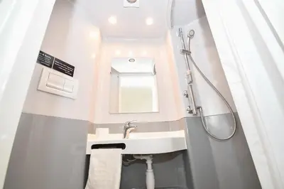 a bathroom with a sink and a shower at Spacious 13 Bedroom Apartment in Liverpool in Liverpool