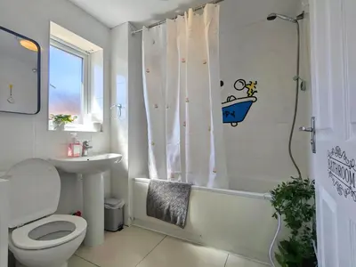 a bathroom with a toilet and a sink and a shower at Stylish 4-Bed, 3-Bath Townhouse with Free Parking in Liverpool