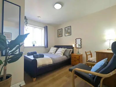 a living room with a bed and a couch at Stylish 4-Bed, 3-Bath Townhouse with Free Parking in Liverpool