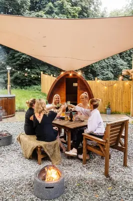 a group of women sitting around a table in a backyard at The Southworth Spa at Samlesbury Hall in Samlesbury