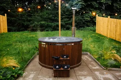 a wooden jacuzzi tub in a yard at The Southworth Spa at Samlesbury Hall in Samlesbury