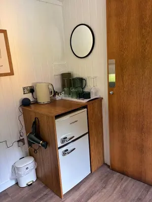 a small kitchen with a counter and a refrigerator at The Southworth Spa at Samlesbury Hall in Samlesbury