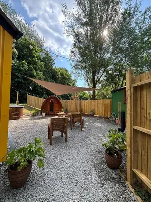 a patio with two benches and a fence at The Southworth Spa at Samlesbury Hall in Samlesbury