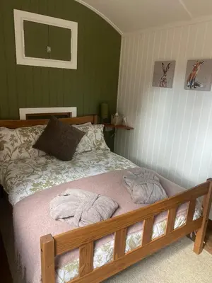 a bedroom with a bed with two towels on it at The Southworth Spa at Samlesbury Hall in Samlesbury