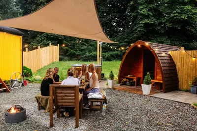 a group of women sitting at a table in front of a tent at The Southworth Spa at Samlesbury Hall in Samlesbury