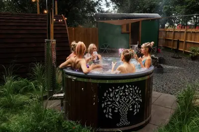 a group of girls in a hot tub in a backyard at The Southworth Spa at Samlesbury Hall in Samlesbury